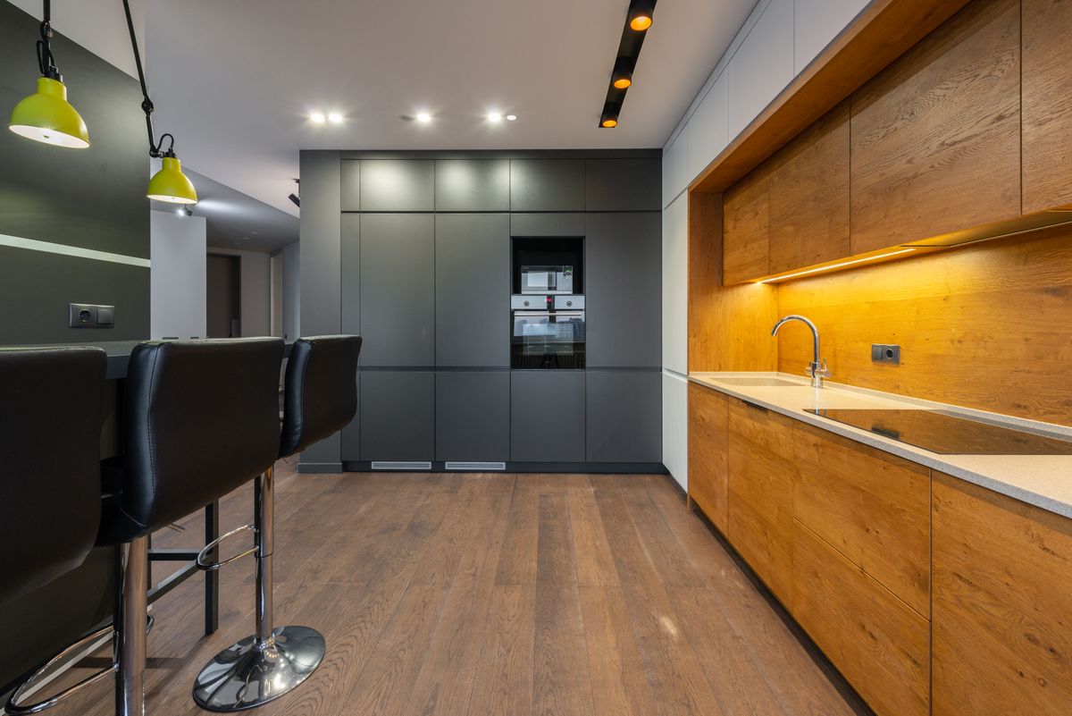 Graphite and oak galley kitchen with a breakfast bar